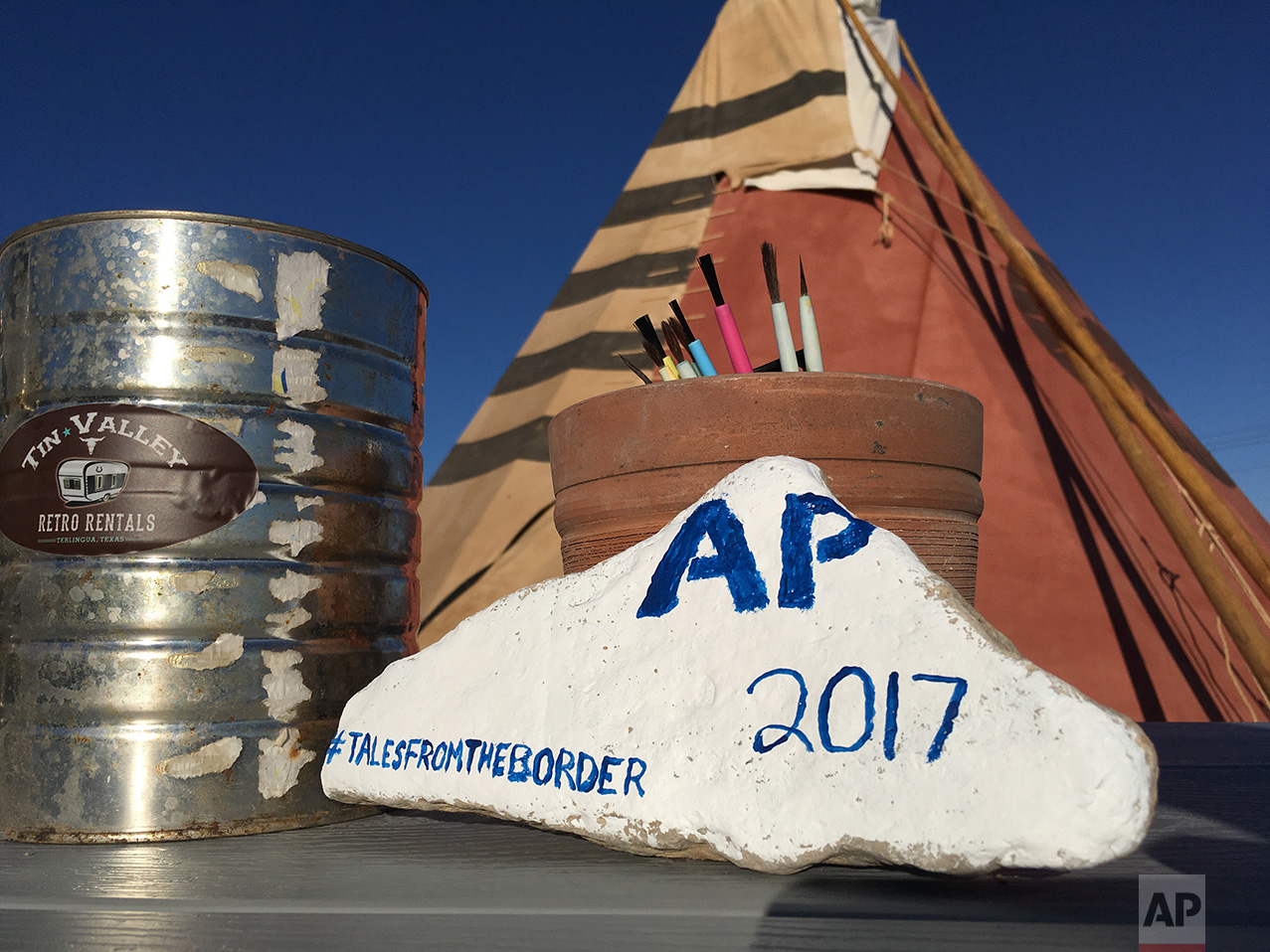  A rock painted by AP journalist Christopher Sherman, at the invitation of Tin Valley Retro Rentals, where overnight guests are encouraged to leave their mark in their desert playground in Terlingua, Texas, near the US-Mexico border, Monday, March 27