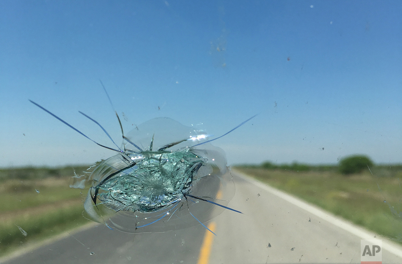  A stone broke the windshield near Piedras Negras, Mexico, Sunday, March 26, 2017, as the AP team drove about 12 hours along the US-Mexico border from The Rio Grand Valley to Terlingua, Texas. The incident delayed them by about two hours as they argu