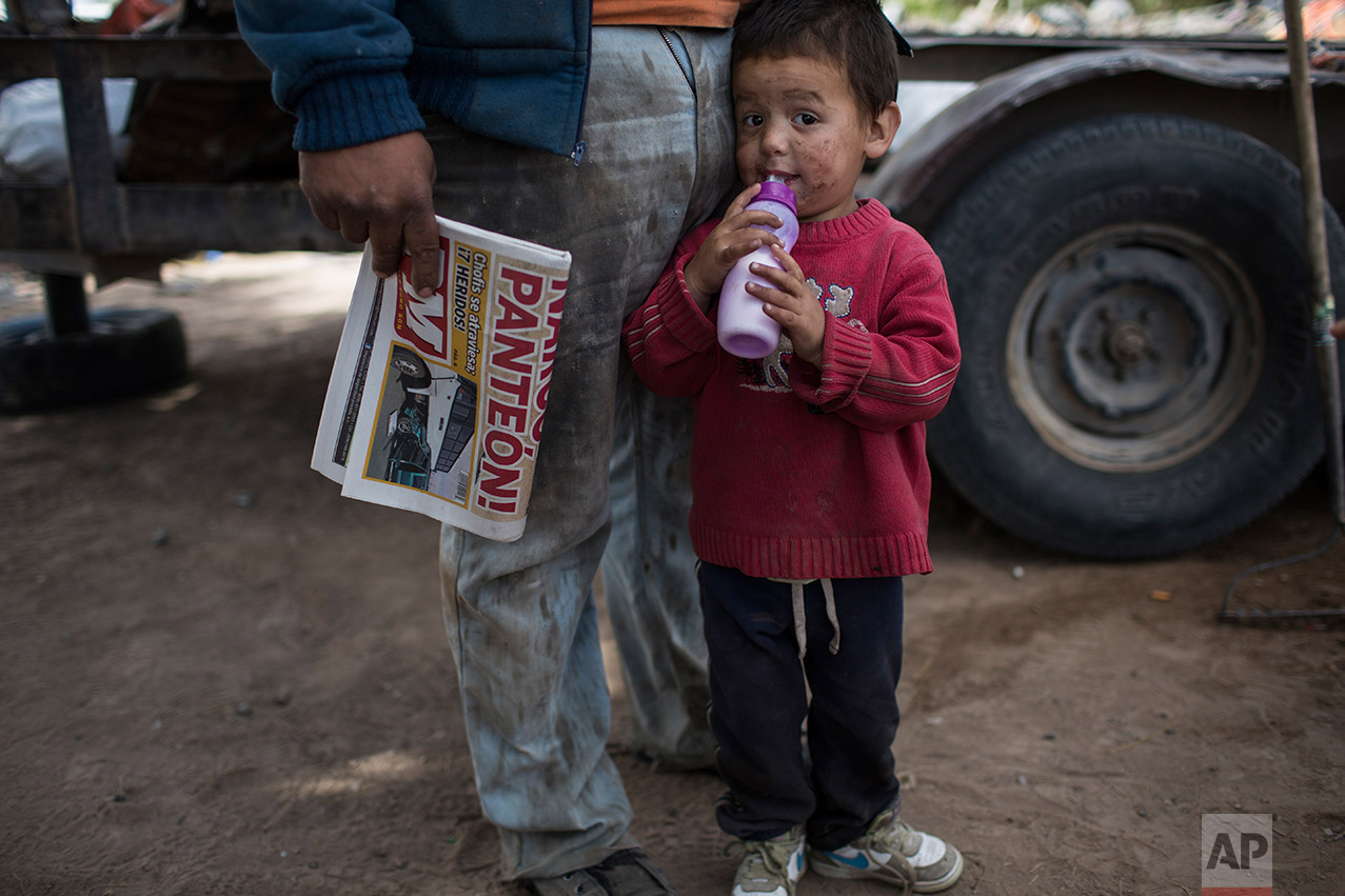  Rohan Ayala stands next to his father outside their home, meters from the fence marking the U.S.-Mexico border in Juarez Valley, Mexico, Wednesday, March 29, 201, across the border from the outskirts of El Paso, Texas. A segment of new fencing is be