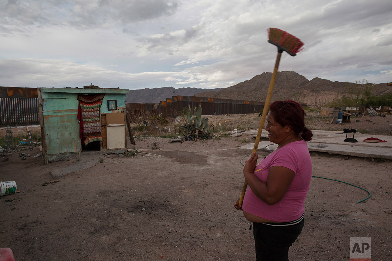  Claudia Sanchez holds a broom outside her shack home in the Anapra neighborhood of Ciudad Juarez, Mexico, Wednesday, March 29, 2017, across the border from Sunland Park, New Mexico. Homes in this area are made of concrete block, wooden pallets, and 