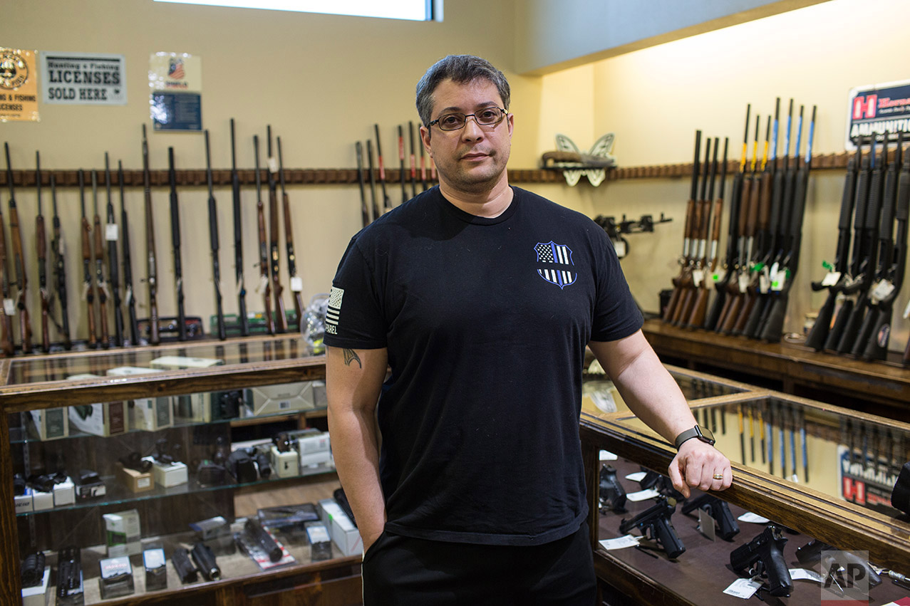 Randy Calderon poses for a photo in the, Sportman's Elite gun shop in El Paso, Texas, Thursday, March 30, 2017. (AP Photo/Rodrigo Abd)