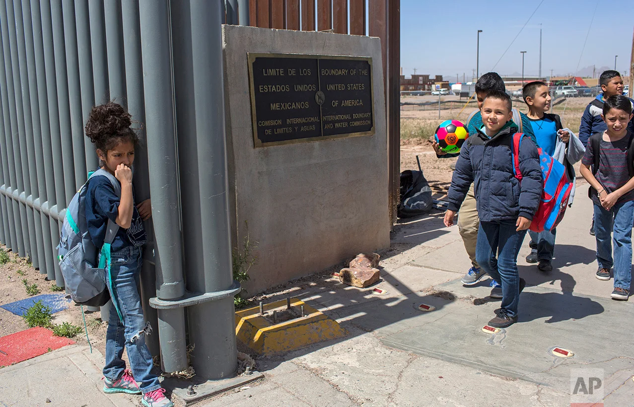 Columbus Elementary School students walk towards the U.S. port of entry on the border with Puerto Palomas, Mexico, after attending school in Columbus, New Mexico, Friday, March 31, 2017. (AP Photo/Rodrigo Abd)