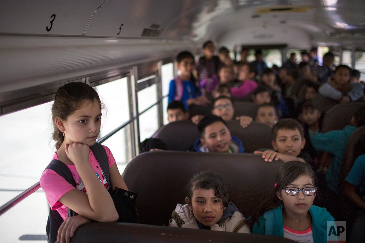 Students wait inside a school bus at Columbus Elementary School, in Columbus, New Mexico, Friday, March 31, 2017, to be transported to the U.S. port of entry on the border with Puerto Palomas, Mexico. (AP Photo/Rodrigo Abd)