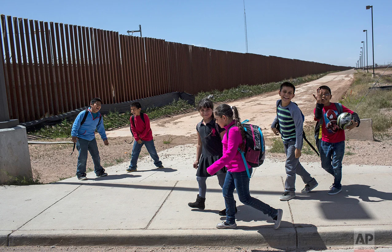 Columbus Elementary School students walk towards the U.S. port of entry on the border with Puerto Palomas, Mexico, after attending school in Columbus, New Mexico, Friday, March 31, 2017. (AP Photo/Rodrigo Abd)