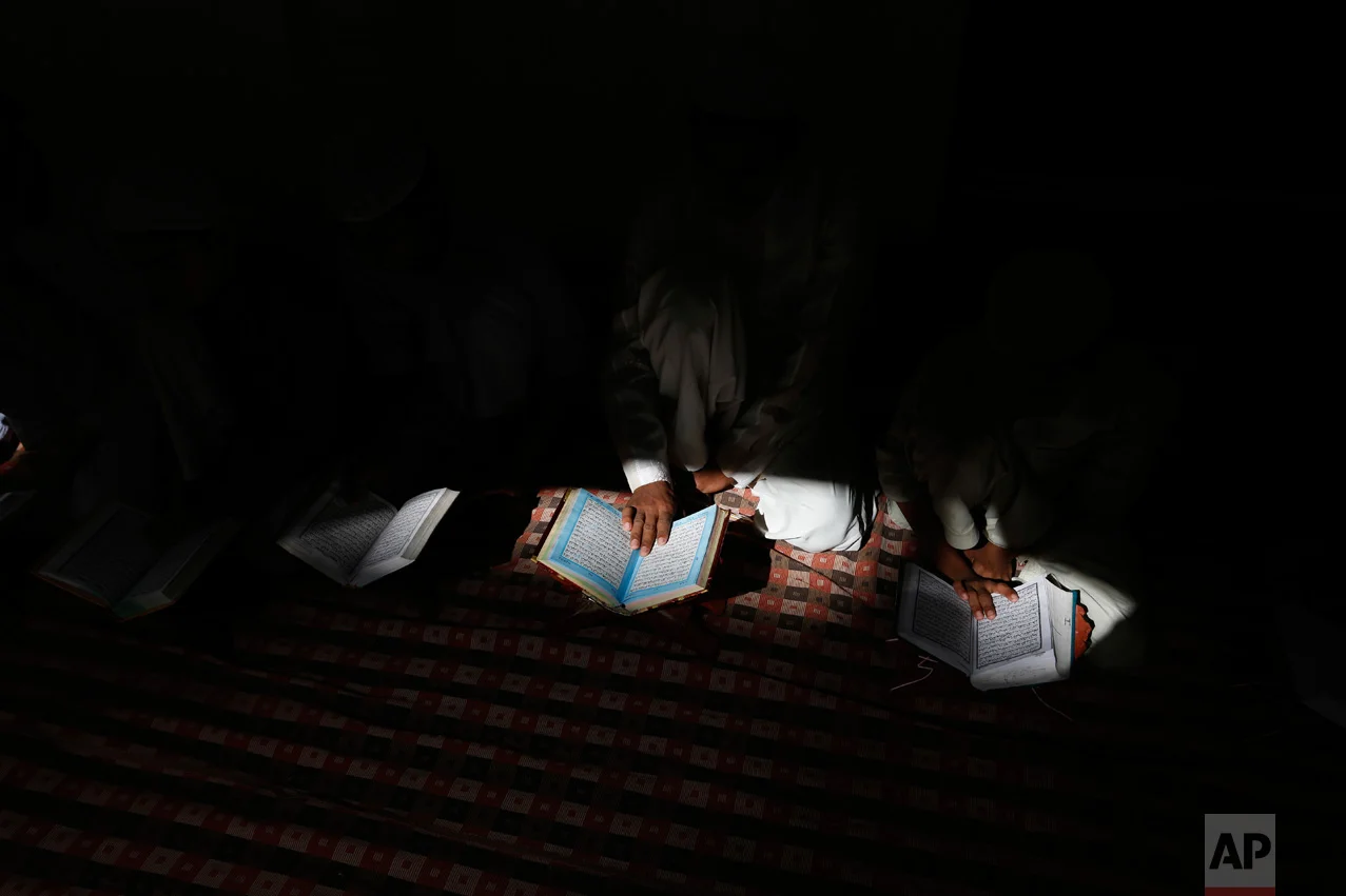 Indian Muslim children read the holy Quran at a mosque in Allahabad, Uttar Pradesh state, India, Tuesday, March 28, 2017. Uttar Pradesh, with a population of 204 million, is India's most populous state. (AP Photo/Rajesh Kumar Singh)