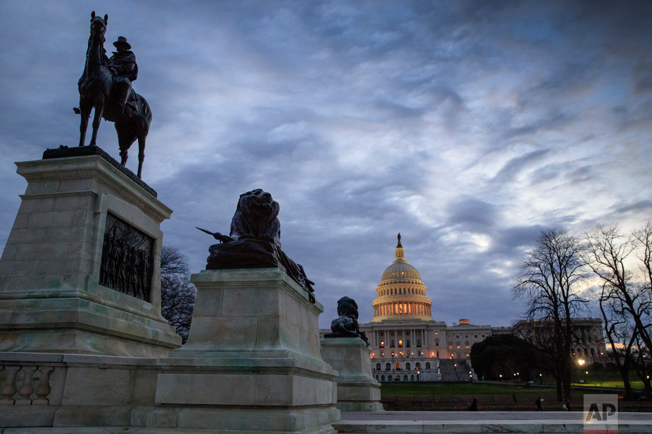 A statue of Civil War General Ulysses S. Grant, left, stands near the U.S. Capitol at dawn in Washington, Thursday, March 30, 2017. (AP Photo/J. Scott Applewhite)