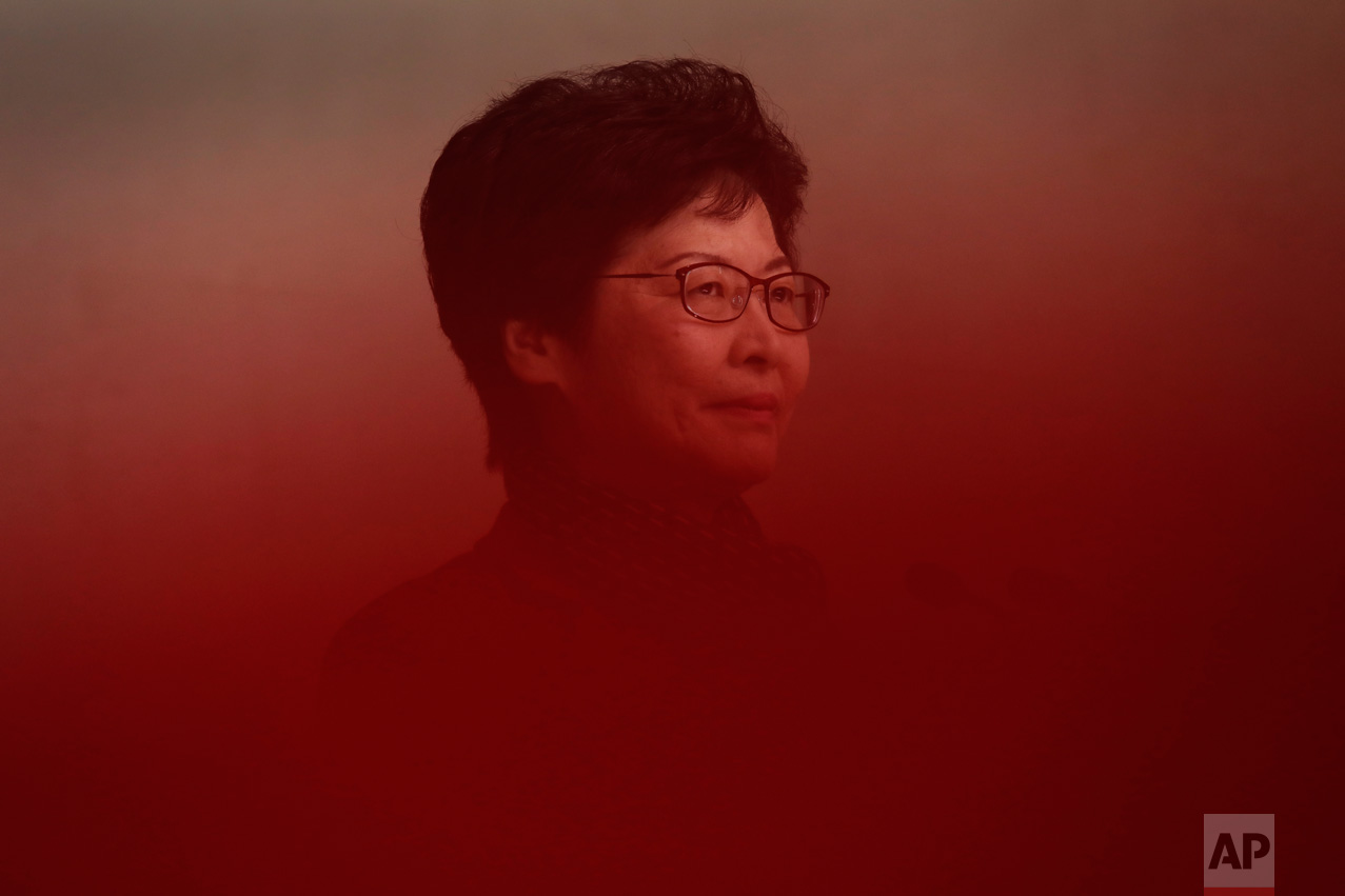 Hong Kong's chief executive elect Carrie Lam stands behind a red ribbon before making a statement after meeting with current chief executive Leung Chun-ying at government headquarters in Hong Kong, Monday, March 27, 2017. The candidate favored by China's Communist leadership was chosen as Hong Kong's new leader a day earlier, in the first such vote since huge pro-democracy protests erupted over the semiautonomous Chinese city's election system in 2014. (AP Photo/Vincent Yu)