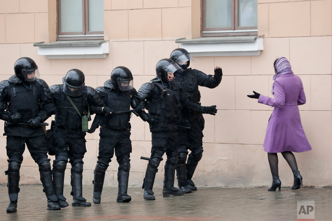 A woman argues with Belarus police officers blocking a street during an opposition rally in Minsk, Belarus, Saturday, March 25, 2017. Hundreds of people were arrested over the weekend after unsanctioned protests against authoritarian President Alexander Lukashenko in the capital. The protests followed sporadic demonstrations across the country over the past two months, an unusually persistent show of defiance in the former Soviet republic. (AP Photo/Sergei Grits)