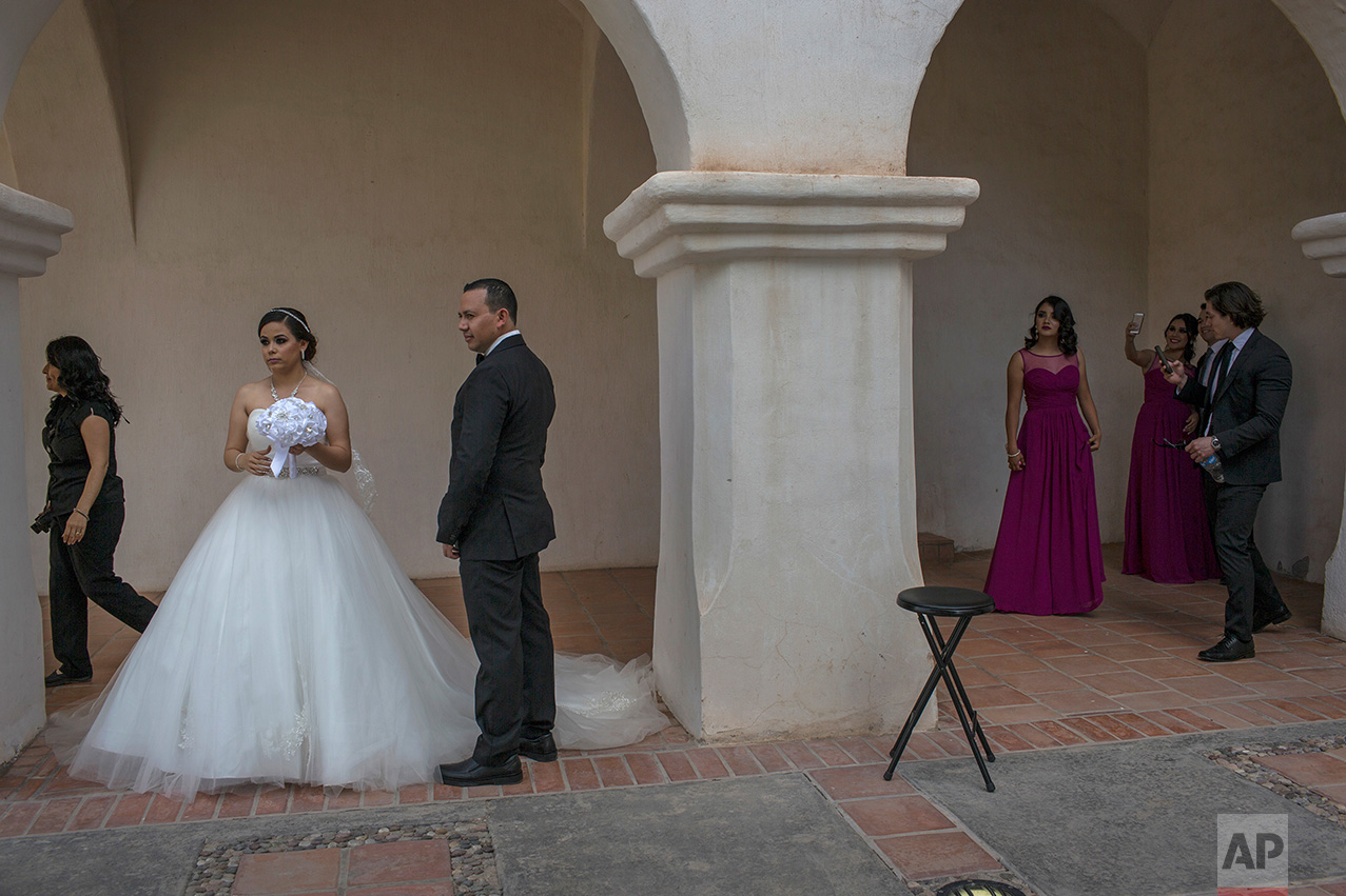  Newlyweds Aldo and Brenda Norris wait for their wedding photographer outside a church in Caborca, Sonora state, Mexico, Saturday, April 1, 2017. Caborca lies in traditional tribal lands of the Tohono O'odham indigenous people, a region that straddle