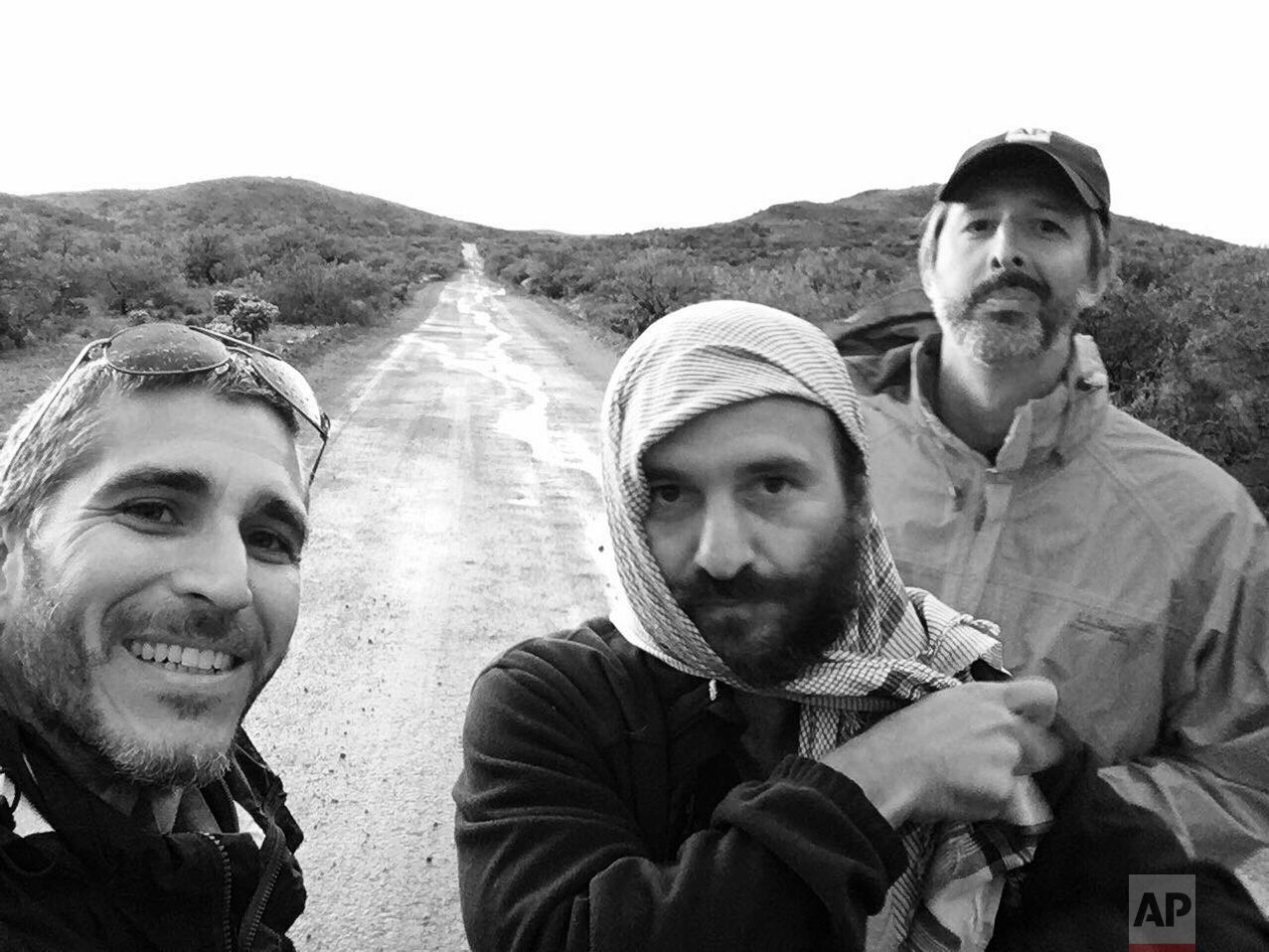  AP video journalist Brian Skoloff, from left, AP photographer Rodrigo Abd and AP correspondent Christopher Sherman, pose fro a group photo on the outskirts of Sasabe, in the Mexican state of Sonora, near the border with Arizona, April 1, 2017. (AP P