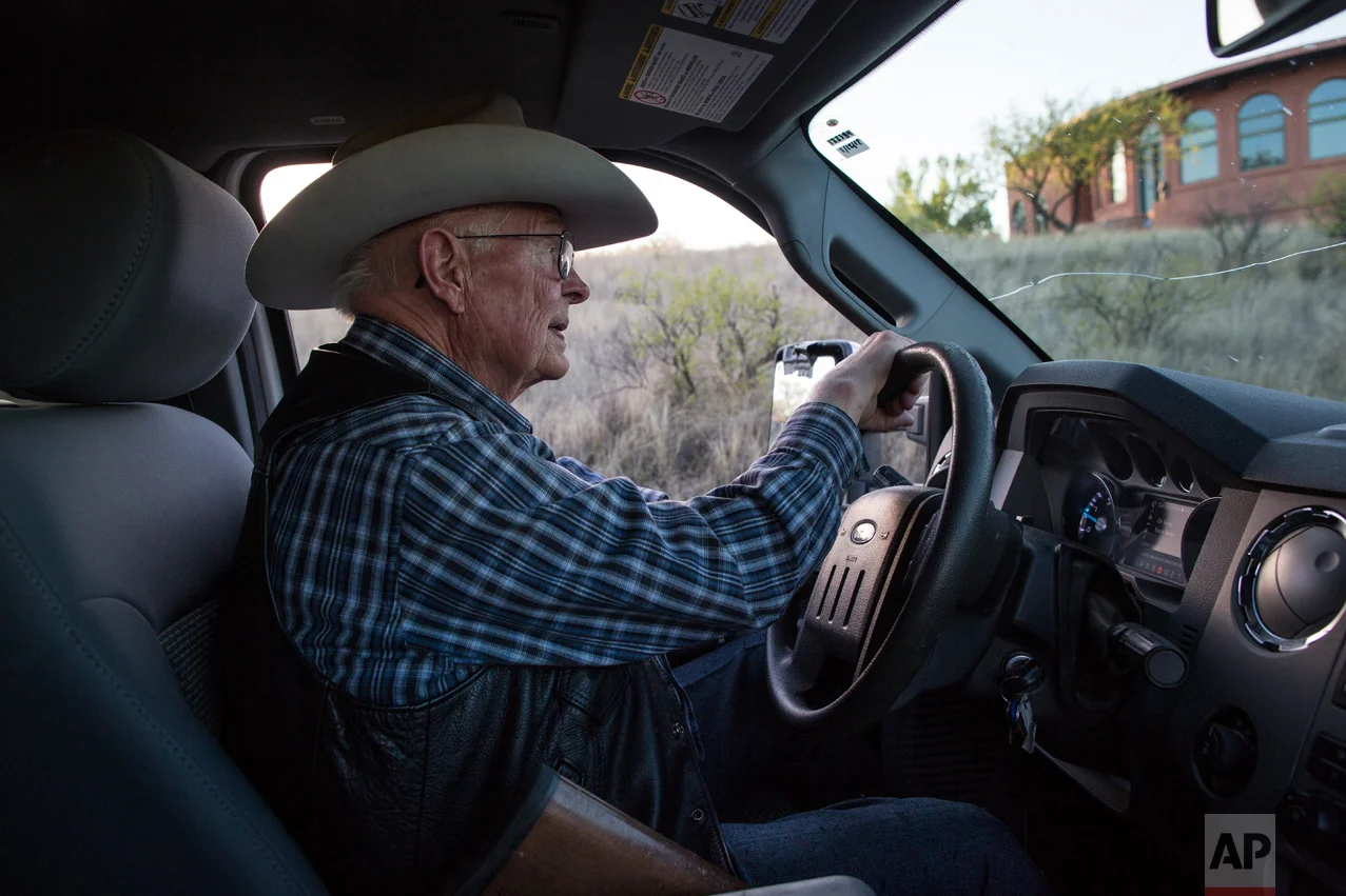 Rancher Jim Chilton drives his pick-up truck on his property which includes a 5 ½-mile stretch of border that's marked only by a four-strand barbed wire fence, in Arivaca, Ariz., Sunday, April 2, 2017. (AP Photo/Rodrigo Abd)