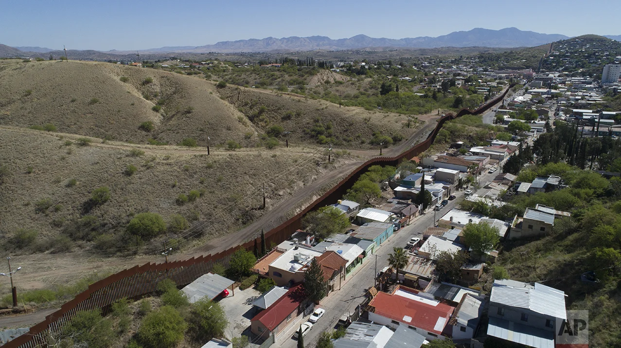 A drone's view of the US-Mexico border fence as seen from Nogales, Mexico, Sunday, April 2, 2017. (AP Photo/Brian Skoloff)