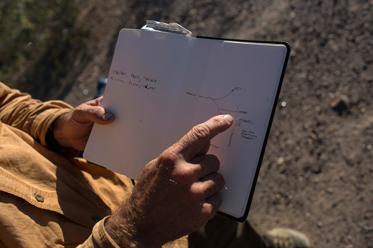 Mark Hainds points to a map he drew that shows where he will sleep for the night, during his border trek, near Why, Arizona, Monday, April 3, 2017. (AP Photo/Rodrigo Abd)