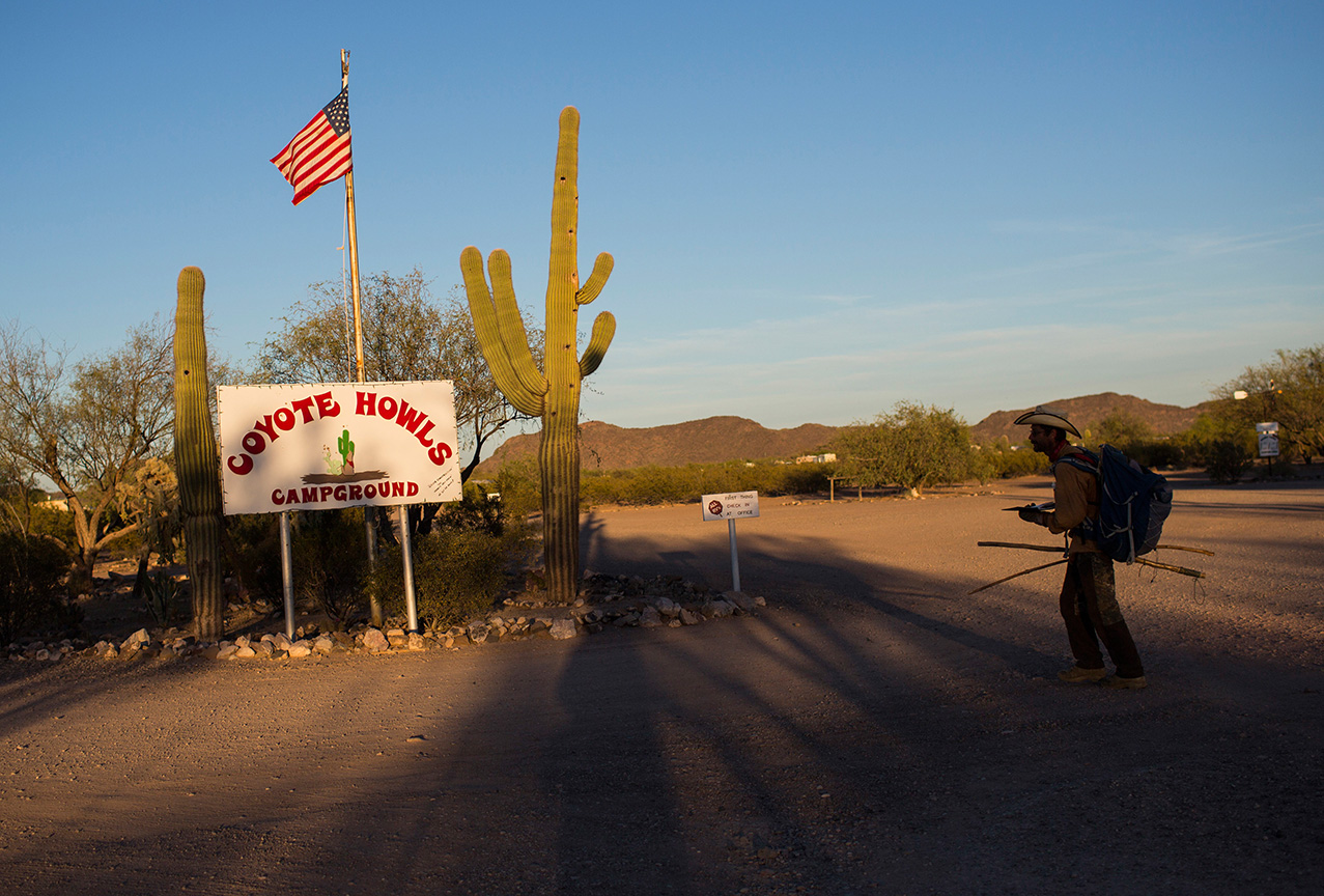 Mark Hainds, who is traveling the length of the U.S.-Mexico border by foot, arrives at the Coyote Howls RV park near Why, Arizona, Monday, April 3, 2017. (AP Photo/Rodrigo Abd)