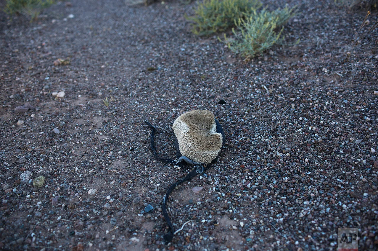 A pair of what is known as "carpet shoes", used by drug smugglers to hide their tracks, lies abandoned on the side of a remote highway near Why, Arizona, Monday, April 3, 2017. (AP Photo/Rodrigo Abd)