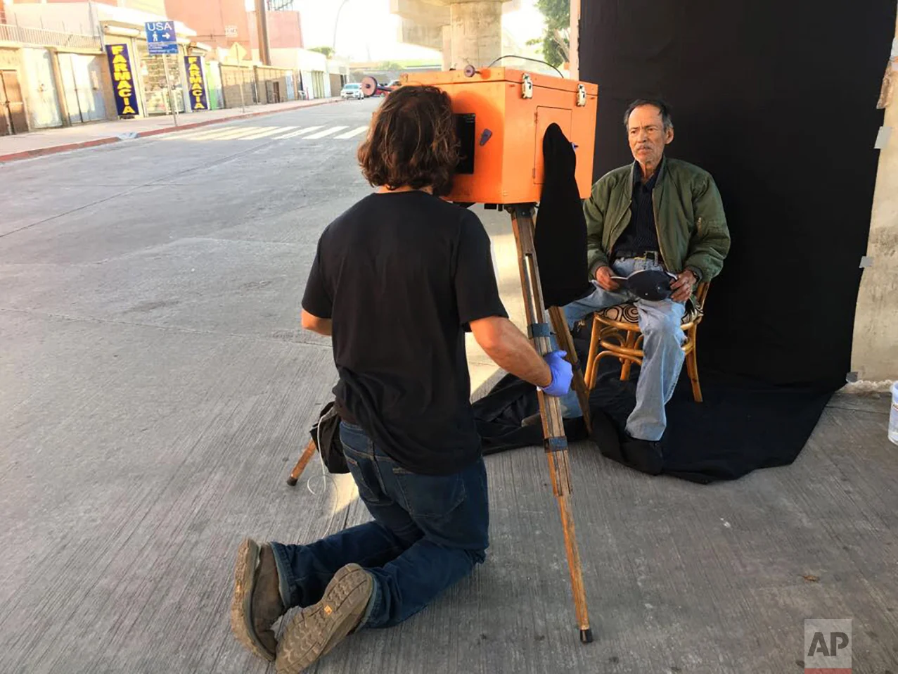 AP photographer Rodrigo Abd uses a wooden box camera to make a portrait of Mexican retiree Miguel Trejo, in Tijuana, Mexico, Wednesday, April 5, 2017. (AP Photo/Jordi Lebrija)