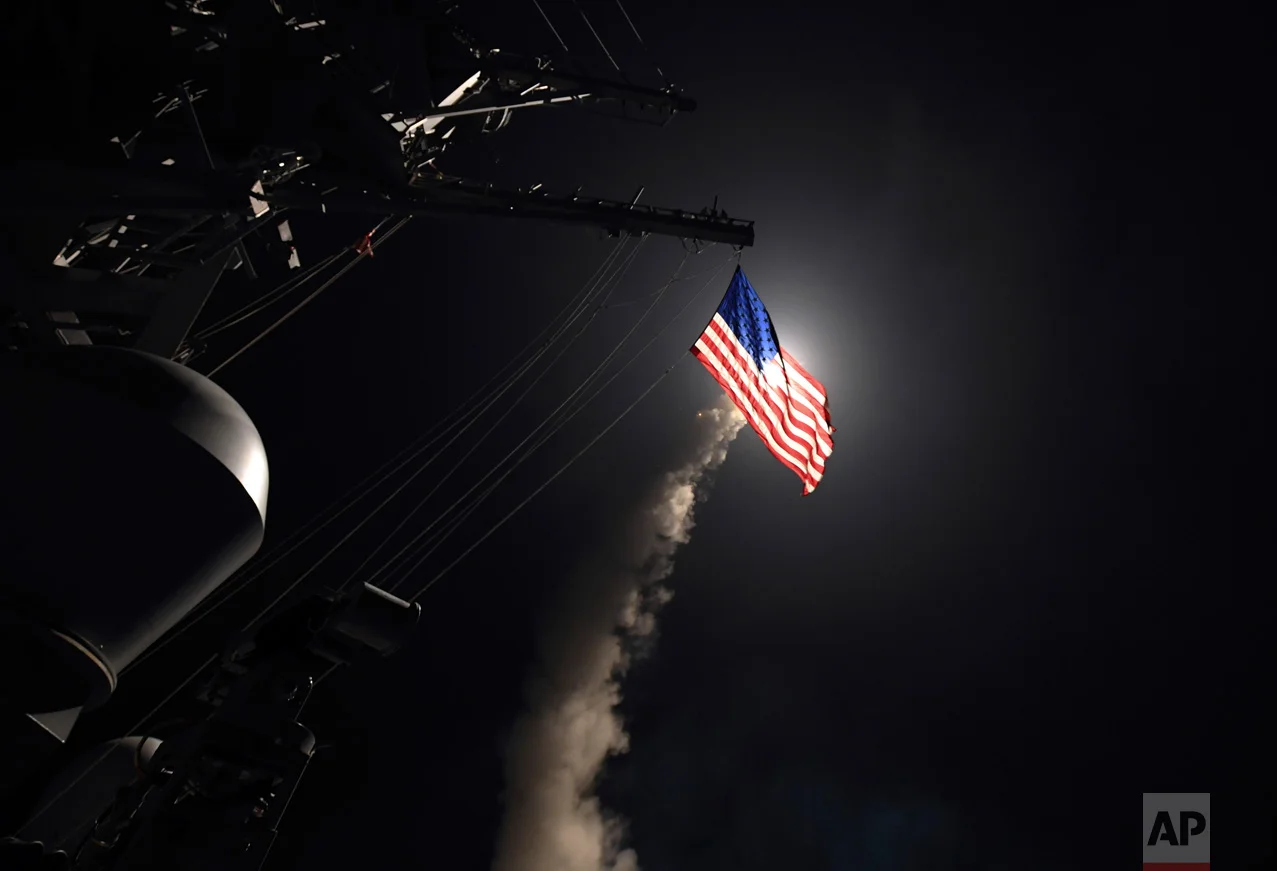 In this image provided by the U.S. Navy, the guided-missile destroyer USS Porter (DDG 78) launches a tomahawk land attack missile in the Mediterranean Sea, Friday, April 7, 2017. The United States blasted a Syrian air base with a barrage of cruise missiles in retaliation for a chemical weapons attack against civilians. (Mass Communication Specialist 3rd Class Ford Williams/U.S. Navy via AP)