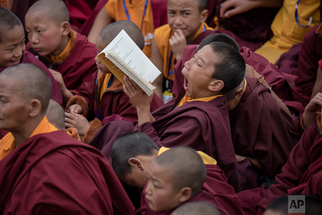 A young Tibetan monk yawns during teachings by the Dalai Lama, at the Thupsung Dhargyeling Monastery in Dirang, Arunachal Pradesh, India, Thursday, April 6, 2017. The Dalai Lama consecrated the Buddhist monastery on Thursday in India's remote northeast, amid Chinese warnings that the exiled Tibetan spiritual leader's visit to the disputed border region would damage bilateral relations with India. (AP Photo/Tenzin Choejor)