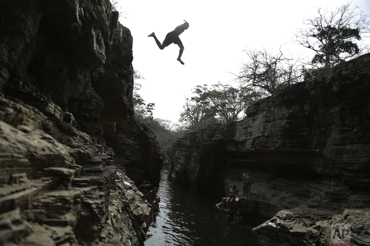 A man jumps into Los Cajones river in Chame, Panama, on Thursday, April 6, 2017. (AP Photo/Arnulfo Franco)