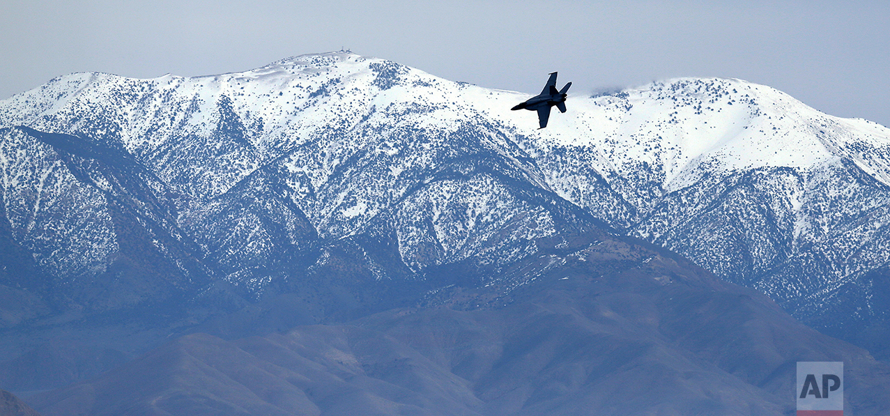 In this Feb. 27, 2017, photo, an F/A-18E Super Hornet from VFA-24 squadron at NAS Lemoore banks in front of the Panamint range while exiting the nicknamed Star Wars Canyon on the Jedi transition over Death Valley National Park, Calif. Military jets roaring over national parks have long drawn complaints from hikers and campers. (AP Photo/Ben Margot)