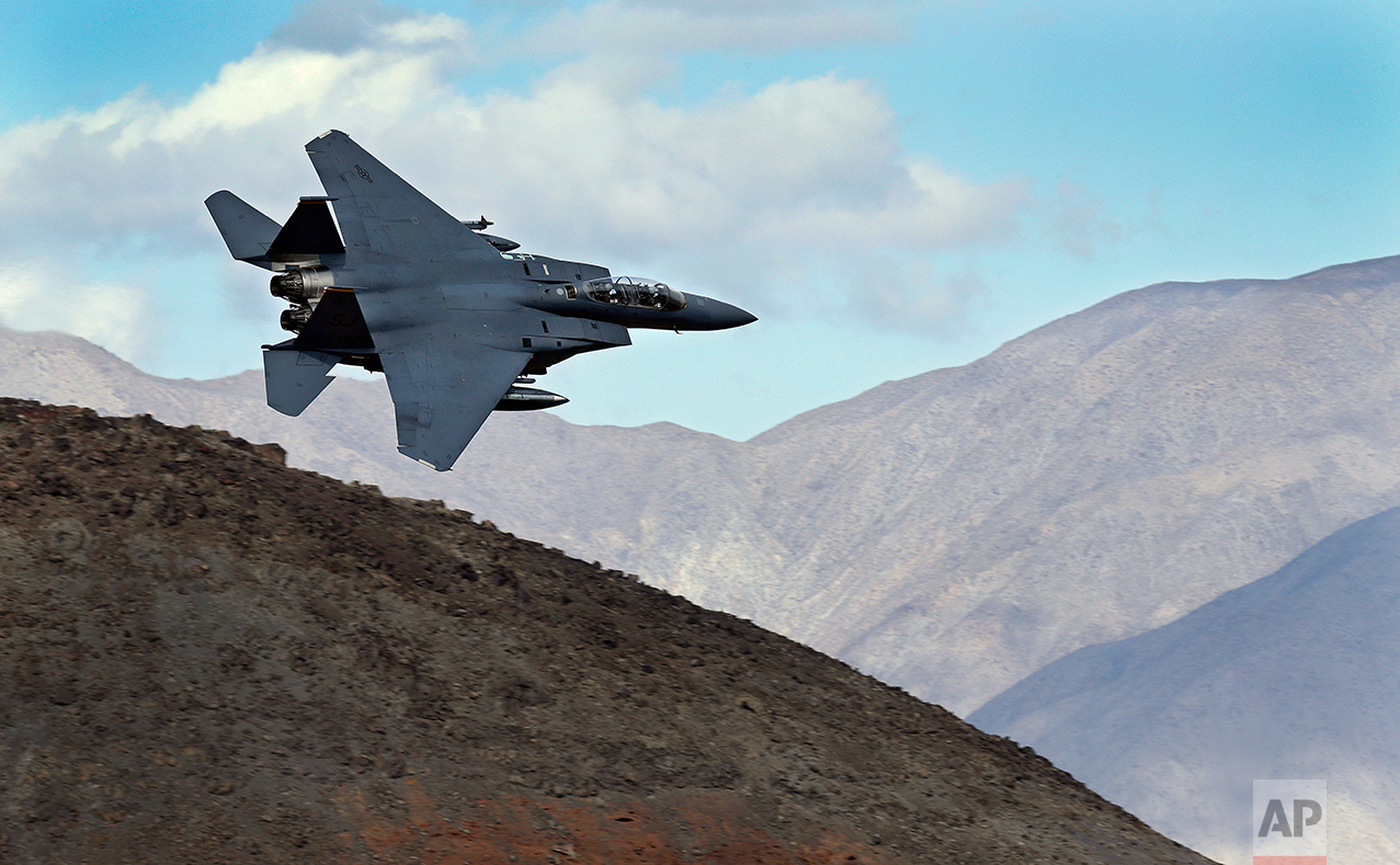 In this Feb. 27, 2017, photo an F-15E Strike Eagle from Seymour Johnson AFB in North Carolina flies out of the nicknamed Star Wars Canyon turning toward the Panamint range over Death Valley National Park, Calif. (AP Photo/Ben Margot)