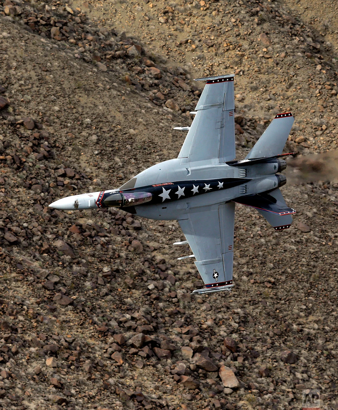 In this Feb. 27, 2017, photo, Lt. Cmdr. Ian "Elf" Kibler of the VX-9 Vampire squadron from Naval Air Weapons Station, China Lake, banks his F/A-18E Super Hornet through the nicknamed Star Wars Canyon in Death Valley National Park, Calif. (AP Photo/Ben Margot)
