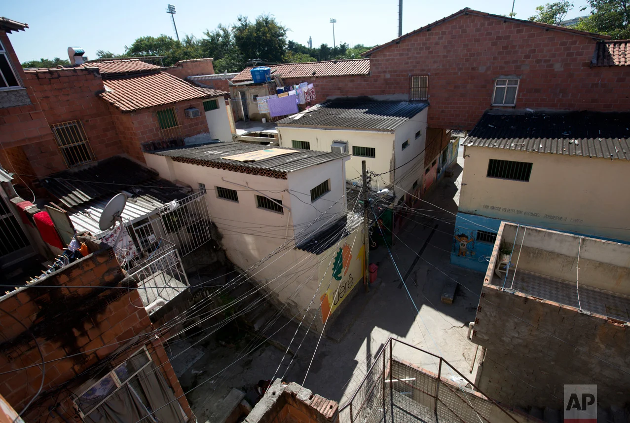 This April 5, 2017 photo shows the rooftop of the Uere special needs school in the Mare slum in Rio de Janeiro, Brazil. Last month a helicopter taking part in a police operation hovered over the school and opened fire for several minutes, with some of the rounds striking the building. Nobody inside was hurt, but afterward the school's founder installed a bright yellow sign on the rooftop that reads, in big, black capital letters: "SCHOOL, DON'T SHOOT." (AP Photo/Silvia Izquierdo)