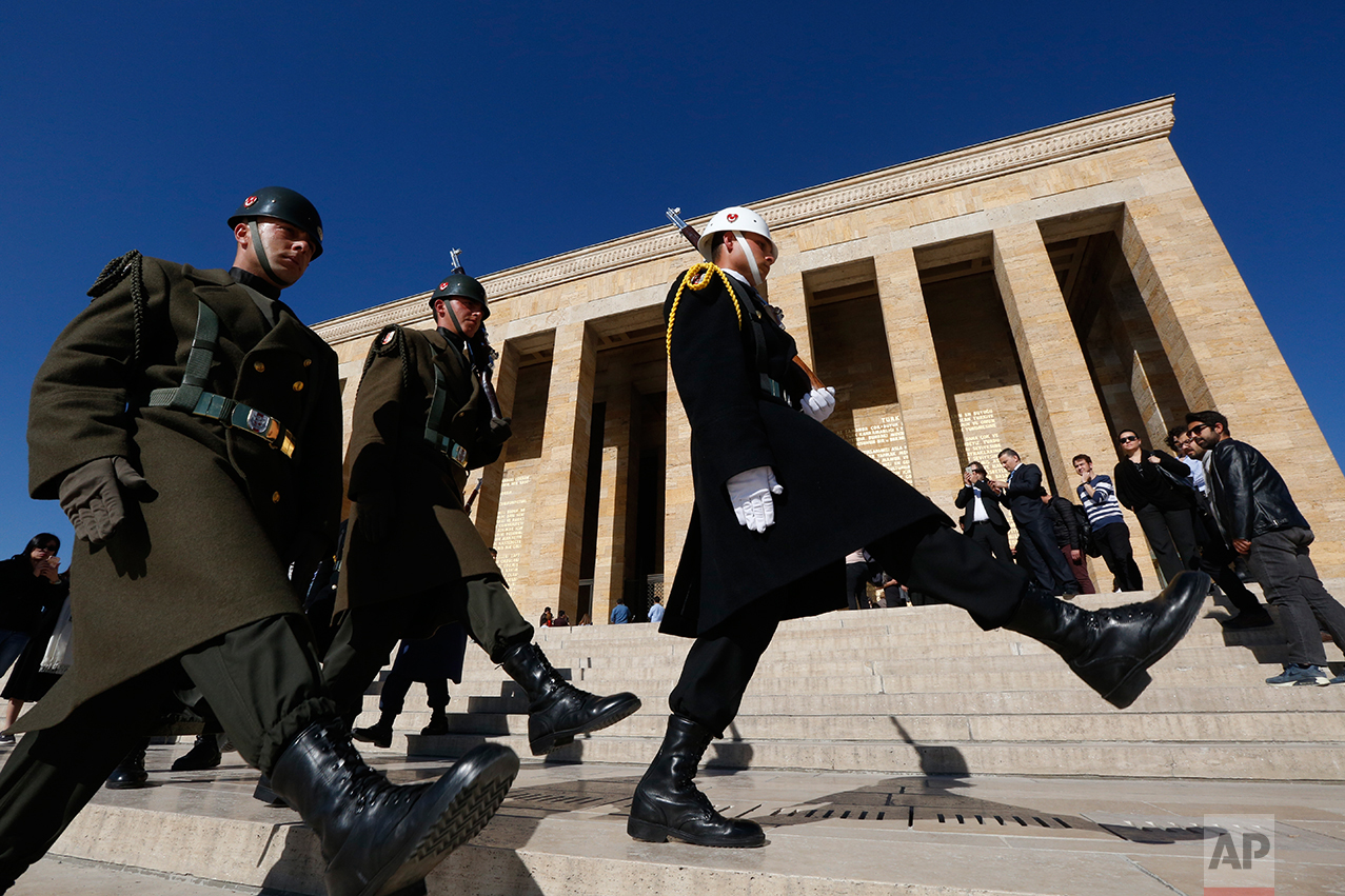 In this March 29, 2017 photo, Turkish military honour guards perform the hourly changing of the guard at the mausoleum of Mustafa Kemal Ataturk, the founder of modern Turkey in Ankara, Turkey. The legacy of the man whose surname means "father of Turks" was one of a modern, secular, western-leaning Turkey. But the personality cult that grew around him has very gradually been fading as current President Recep Tayyip Erdogan, in power since 2003 as alternately prime minister and president, has harked back to the glory days of the height of the Ottoman Empire to whip up patriotic sentiment. (AP Photo/Lefteris Pitarakis)