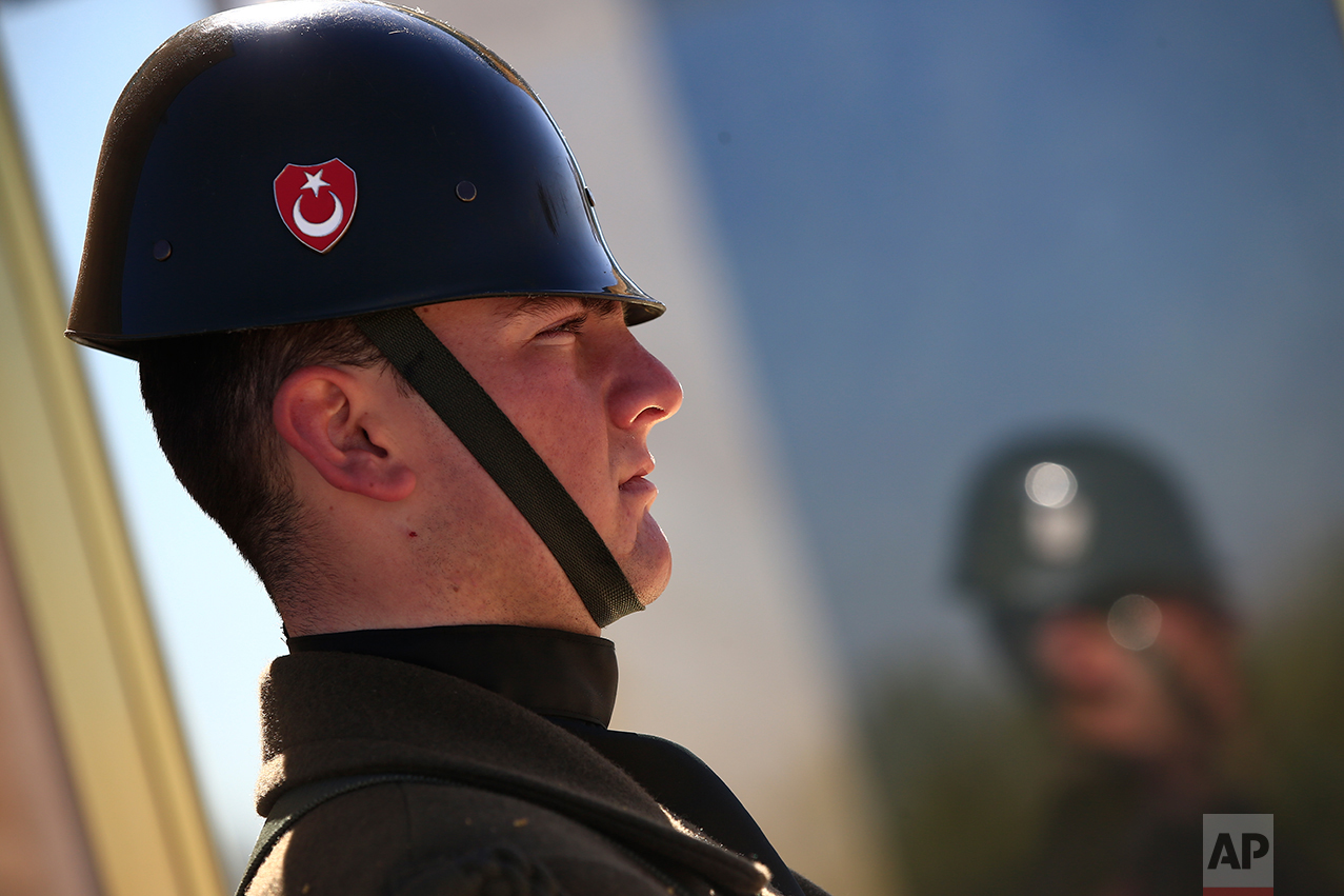 In this March 29, 2017 photo, a Turkish military officer stands as an honour guard outside the mausoleum of Mustafa Kemal Ataturk, the founder of modern Turkey in Ankara, Turkey. The legacy of the man whose surname means "father of Turks" was one of a modern, secular, western-leaning Turkey. Ataturk' mausoleum, a sprawling complex built in the early 1950s in the Turkish capital, is still a place of pilgrimage for many. Families, schoolchildren, elderly people, veiled Muslim women all come to pay homage to his memory.(AP Photo/Lefteris Pitarakis)
