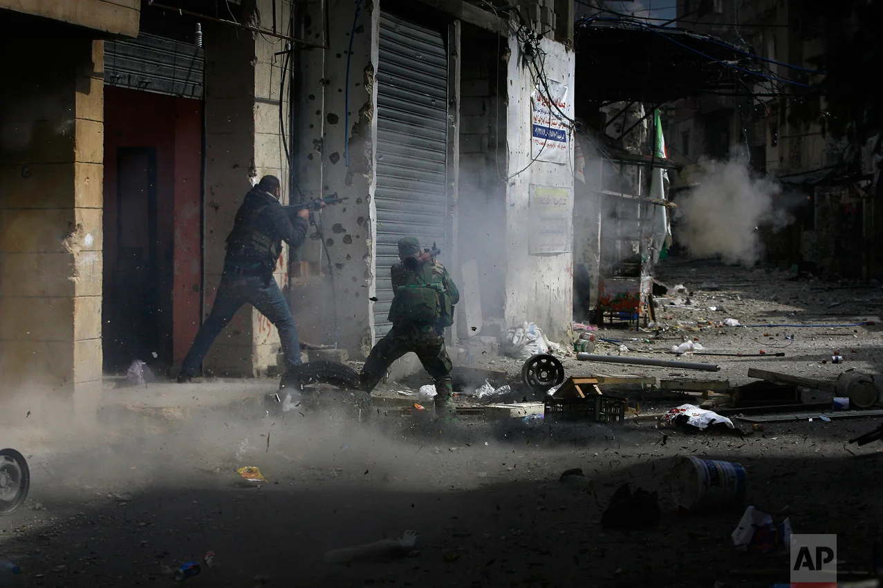 A member of the Palestinian Fatah Movement fires a rocket-propelled grenade during a clash that erupted between the Palestinian Fatah Movement and Islamists in the Palestinian refugee camp of Ein el-Hilweh near the southern port city of Sidon, Lebanon, Sunday, April 9, 2017. Ein el-Hilweh, the largest of 12 Palestinian refugee camps in Lebanon, is notorious for its lawlessness and is home to some extremists who sympathize with the Islamic State group and al-Qaida. (AP Photo/Mohammed Zaatari)