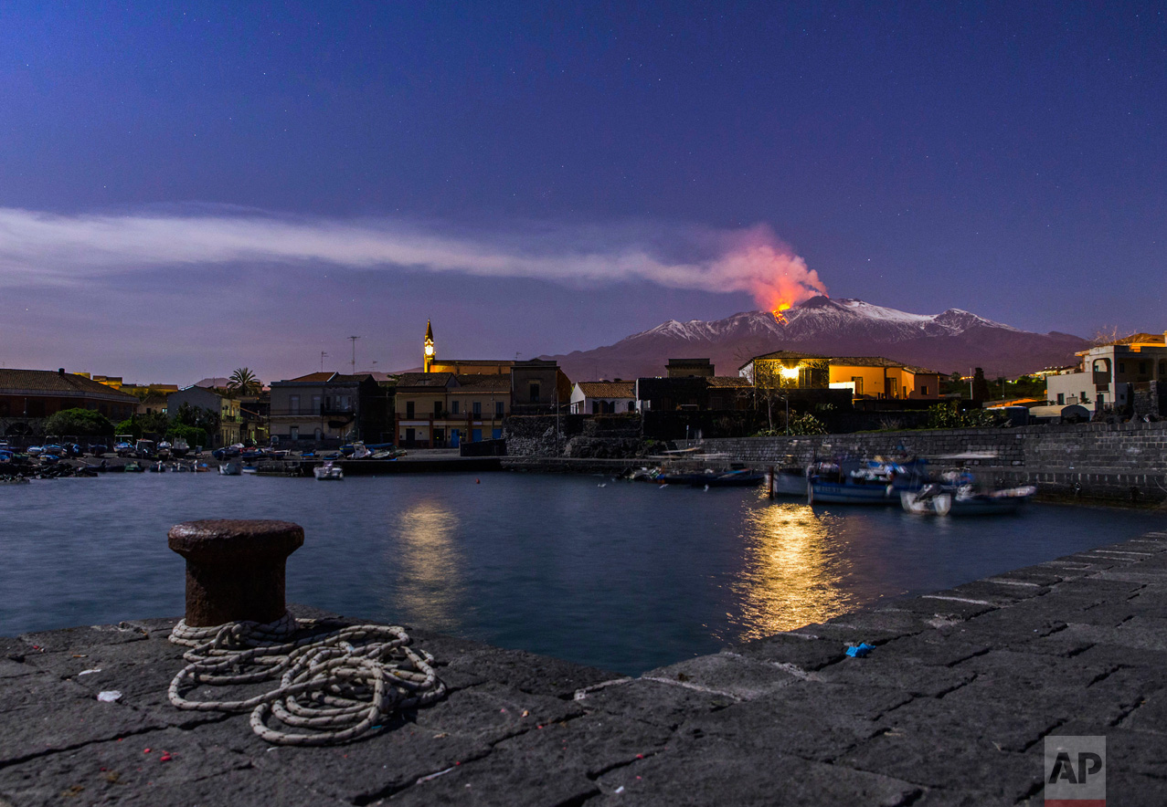 Snow-covered Mount Etna, Europe's most active volcano, spews lava during an eruption seen from the Sicilian village of Pozzillo, Italy, in the early hours of Tuesday, April 11, 2017. (AP Photo/Salvatore Allegra)