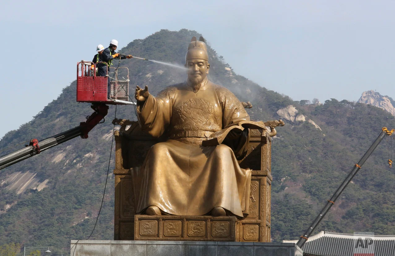 A worker sprays water onto the statue of King Sejong for a spring cleaning at the Gwanghwamun Plaza in Seoul, South Korea, Monday, April 10, 2017. King Sejong, the fourth king of the Joseon Dynasty (1392-1910), created the Korean alphabet, Hangul, in 1446. (AP Photo/Ahn Young-joon)