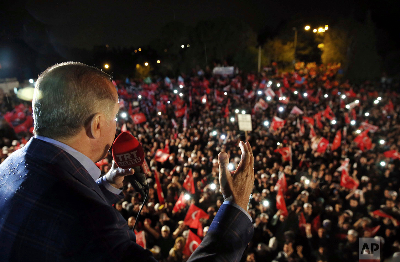 Turkey's President Recep Tayyip Erdogan addresses cheering supporters after unofficial referendum results were announced, in Istanbul, late Sunday, April 16, 2017. (Yasin Bulbul/Presidential Press Service via AP)