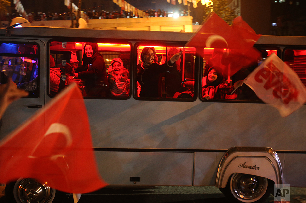 Supporters of the "Yes" vote, celebrate in Istanbul, on Sunday, April 16, 2017. With 97 percent of the ballots counted in Turkey's historic referendum, those who back constitutional changes greatly expanding President Recep Tayyip Erdogan's powers had a narrow lead Sunday night, the official Anadolu news agency said. (AP Photo/Petros Karadjias)