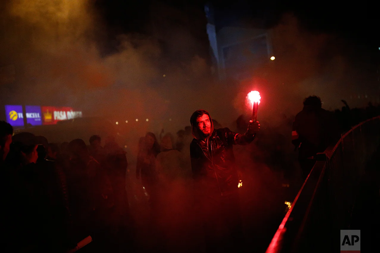 A supporter of the 'no' vote lights a flare during a protest in Istanbul, against the referendum outcome, Monday, April 17, 2017. Turkey's main opposition party urged the country's electoral board Monday to cancel the results of a landmark referendum that granted sweeping new powers to Erdogan, citing what it called substantial voting irregularities. (AP Photo/Emrah Gurel)