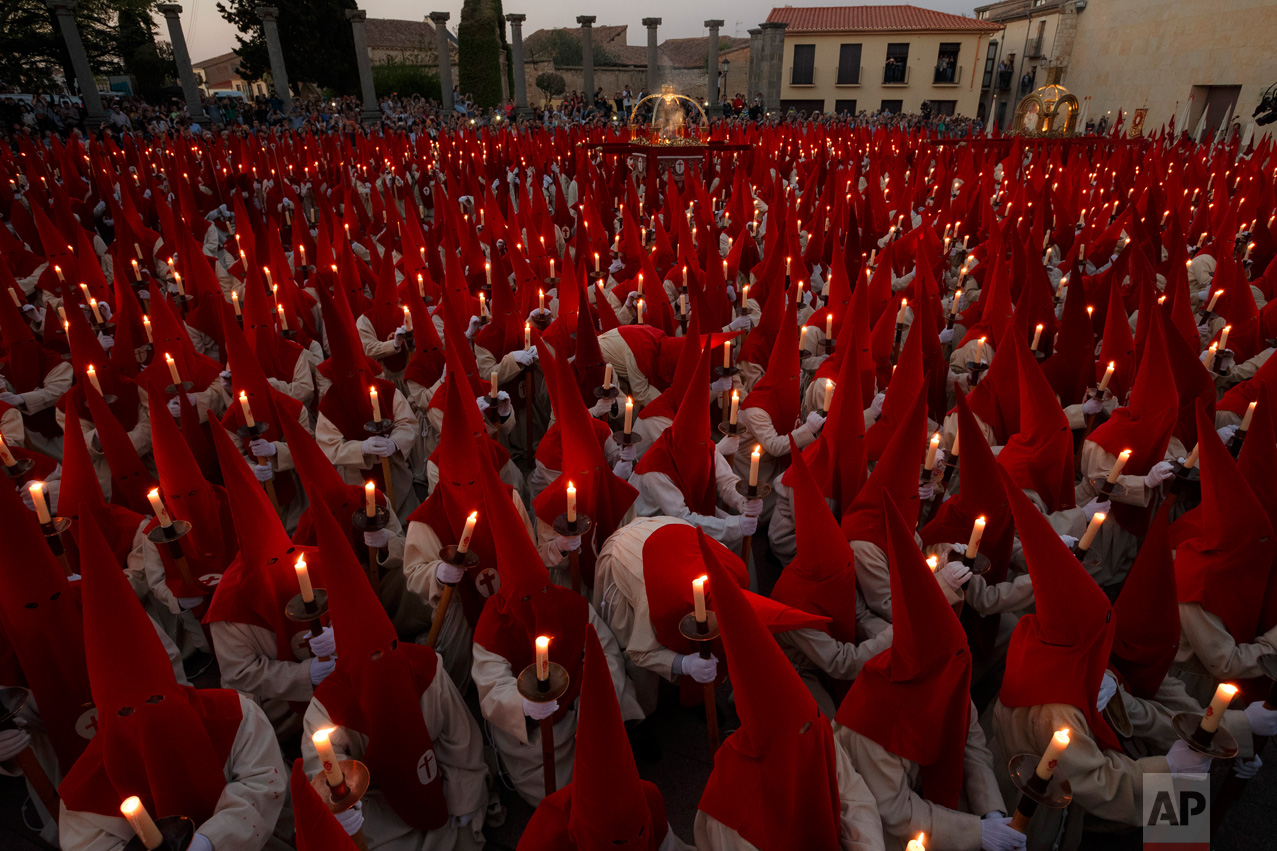 In this Wednesday, April 12, 2017 photo, penitents from 'Real Cofradia del Santisimo Cristo de las Injurias' also known as 'El Silencio' brotherhood take part in a procession in Zamora, Spain. (AP Photo/Daniel Ochoa de Olza)