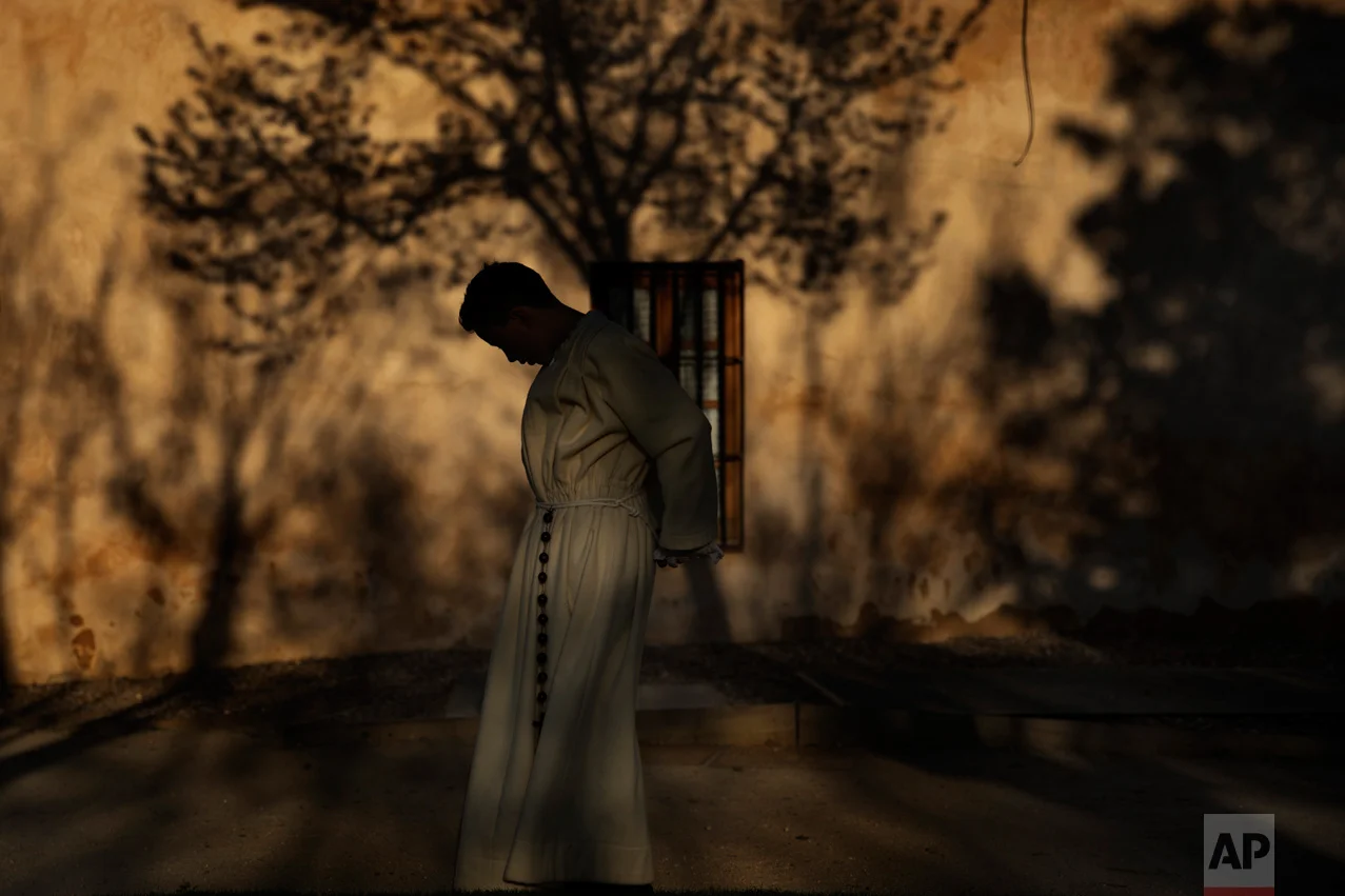 In this Wednesday, April 12, 2017 photo, a penitent from 'Real Cofradia del Santisimo Cristo de las Injurias' also known as 'El Silencio' brotherhood prepares to take part in a procession in Zamora, Spain. (AP Photo/Daniel Ochoa de Olza)
