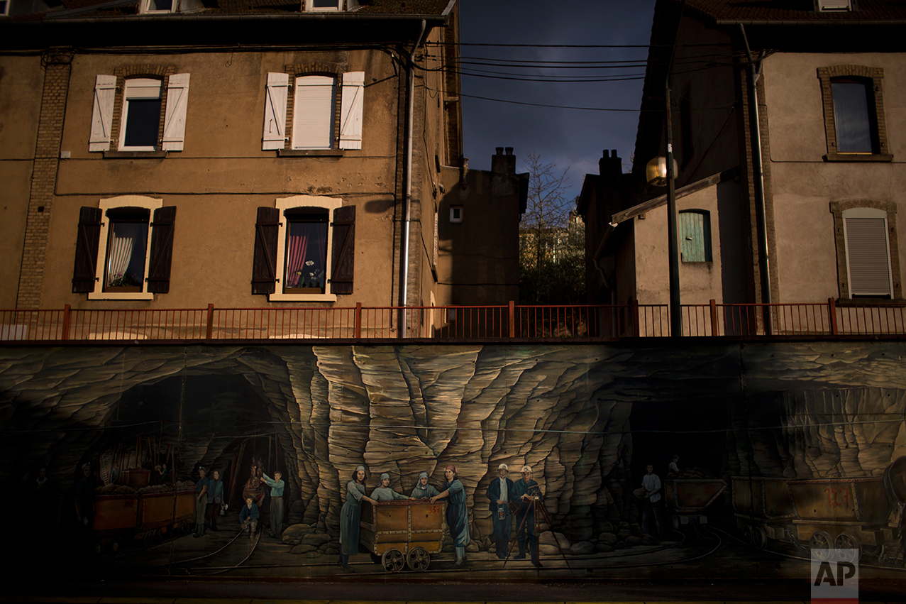 A mural depicting miners is displayed along one of the main streets of Hayange. (AP Photo/Emilio Morenatti)