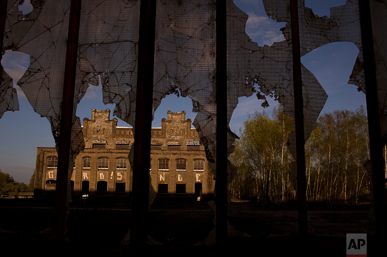 An abandoned steel factory through the broken window of a industrial unit on the outskirts of Rombas, near Hayange. (AP Photo/Emilio Morenatti)