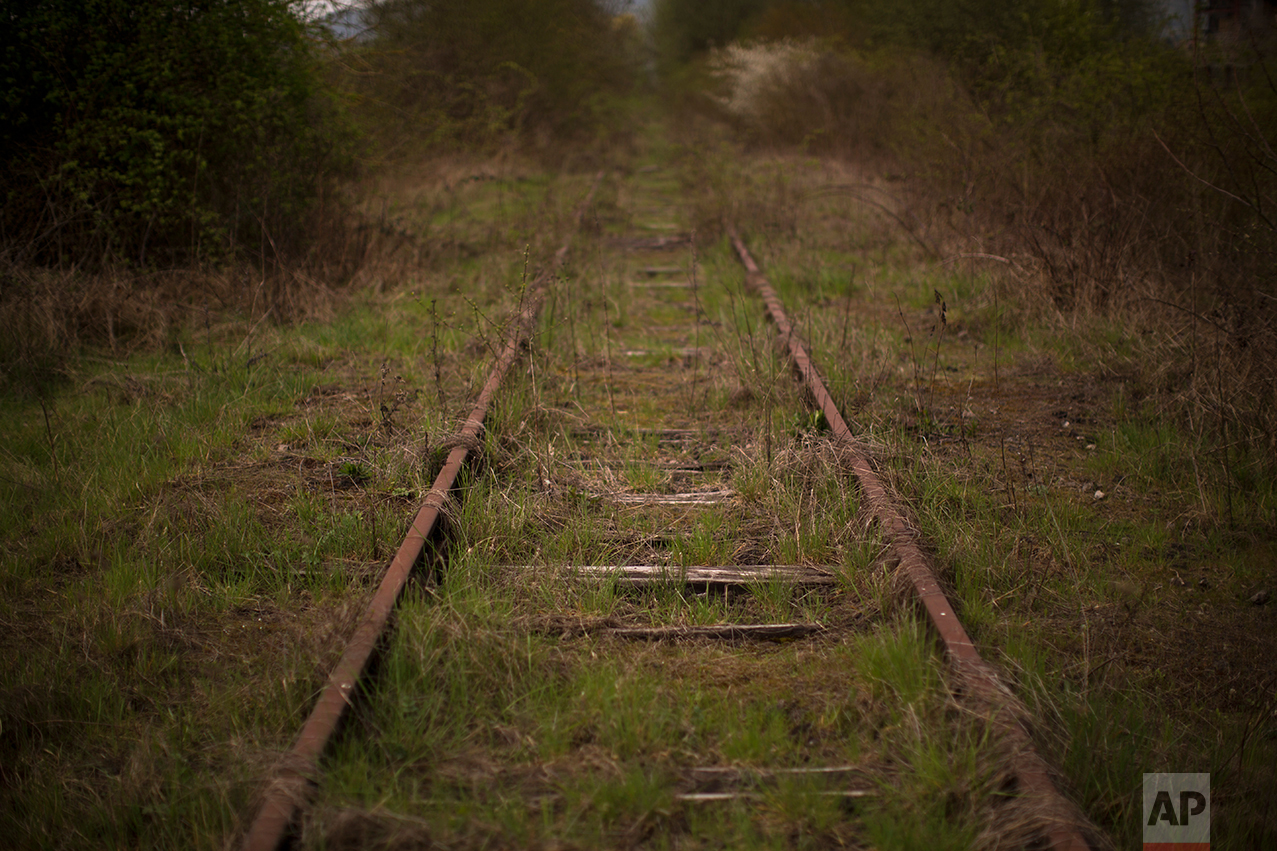 In this Wednesday April 5, 2017 photo, an out of order railroad track leads to an inactive factory in Rombas, a city located in the north east of France, near Hayange. In eastern France’s industrial rustbelt, workers are massing behind the virulently nationalistic politics of populist Marine Le Pen. A large chunk of them will come from once left-leaning industrial towns like Hayange, scarred by the closure of its blast furnaces. (AP Photo/Emilio Morenatti)
