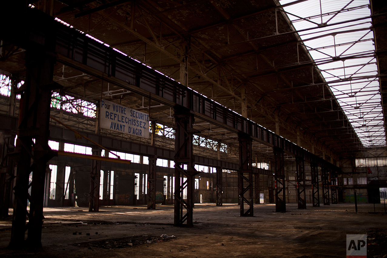 This Wednesday April 5, 2017 photo shows an industrial unit that served as a factory, abandoned on the outskirts of Rombas, a city located in the north east of France, near Hayange. Signs read in French: "For your safety, think before acting." In eastern France’s industrial rustbelt, workers are massing behind the virulently nationalistic politics of populist Marine Le Pen. A large chunk of them will come from once left-leaning industrial towns like Hayange, scarred by the closure of its blast furnaces. (AP Photo/Emilio Morenatti)