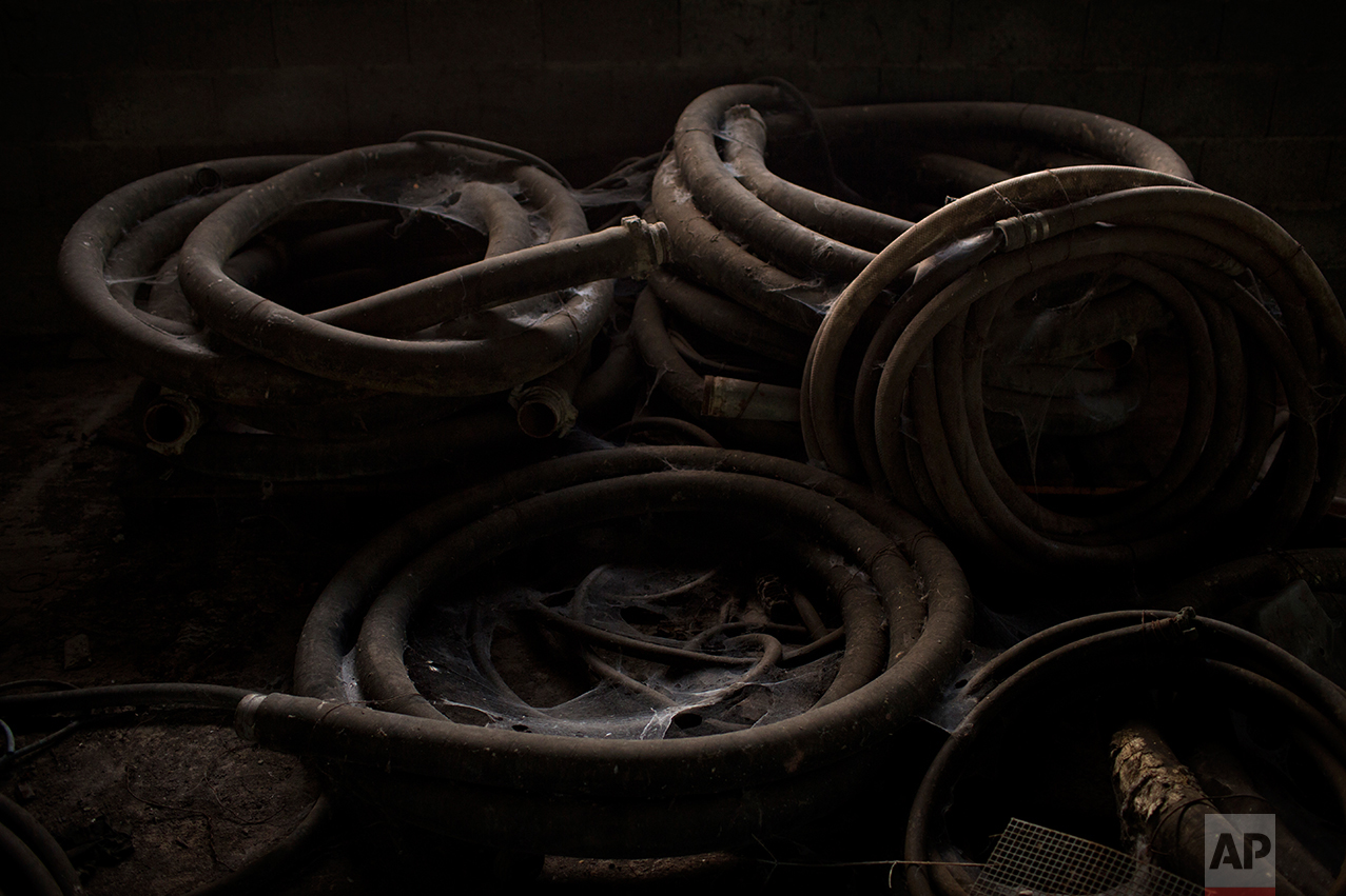 This Monday April 3, 2017 photo shows unloading hoses and couplings covered by dust and cobwebs abandoned inside an inactive factory at Hayange, a commune in the Moselle department in Grand Est in north-eastern France. In eastern France’s industrial rustbelt, workers are massing behind the virulently nationalistic politics of populist Marine Le Pen. A large chunk of them will come from once left-leaning industrial towns like Hayange, scarred by the closure of its blast furnaces. (AP Photo/Emilio Morenatti)