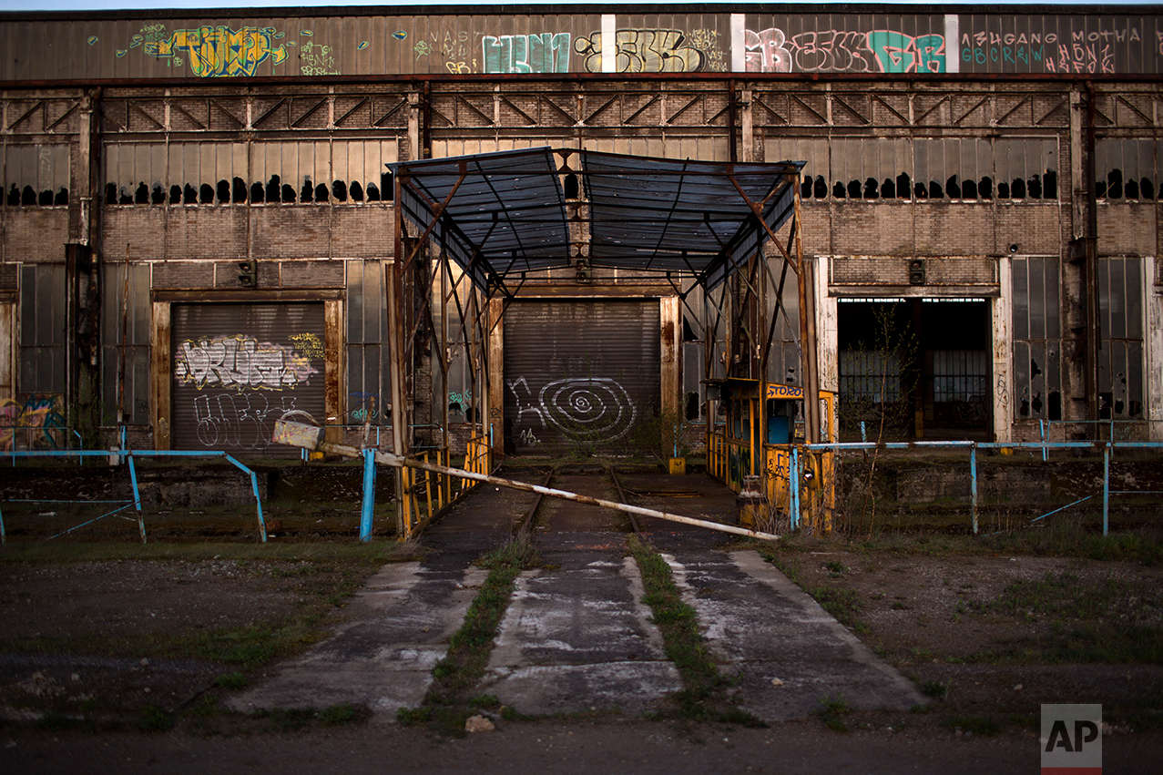 This Thursday April 6, 2017 photo shows the main entrance of a former factory closed and abandoned on the outskirts of Rombas, a city located in the north east of France, near Hayange. In eastern France’s industrial rustbelt, workers are massing behind the virulently nationalistic politics of populist Marine Le Pen. A large chunk of them will come from once left-leaning industrial towns like Hayange, scarred by the closure of its blast furnaces. (AP Photo/Emilio Morenatti)