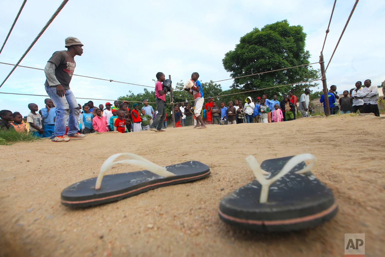 In this Sunday, March 11, 2017 photo, children fight in a boxing ring in Chitungwiza, Zimbabwe. (AP Photo/Tsvangirayi Mukwazhi)