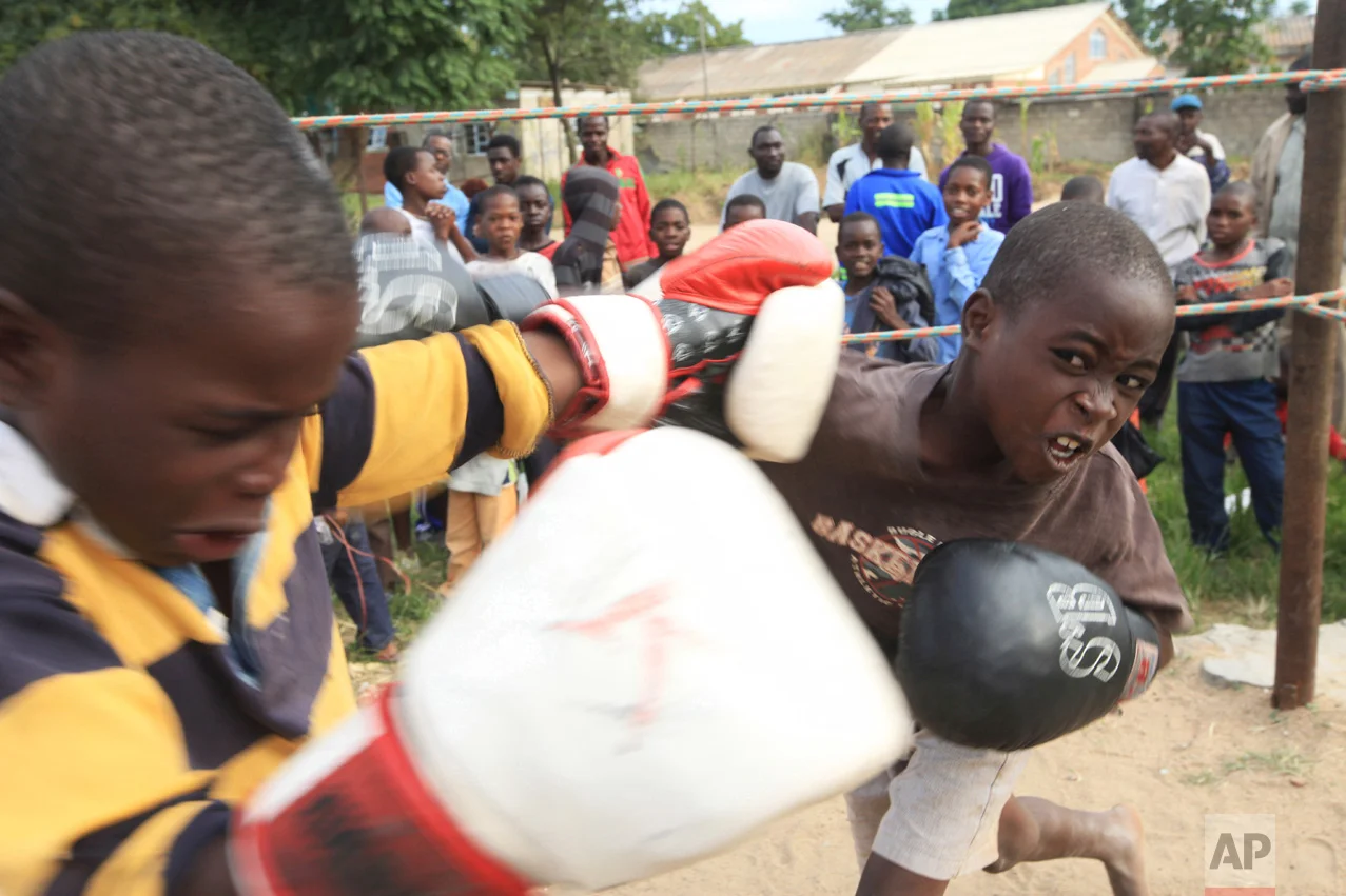 In this Sunday, March 11, 2017 photo, children fight in a boxing ring in Chitungwiza, Zimbabwe. (AP Photo/Tsvangirayi Mukwazhi)