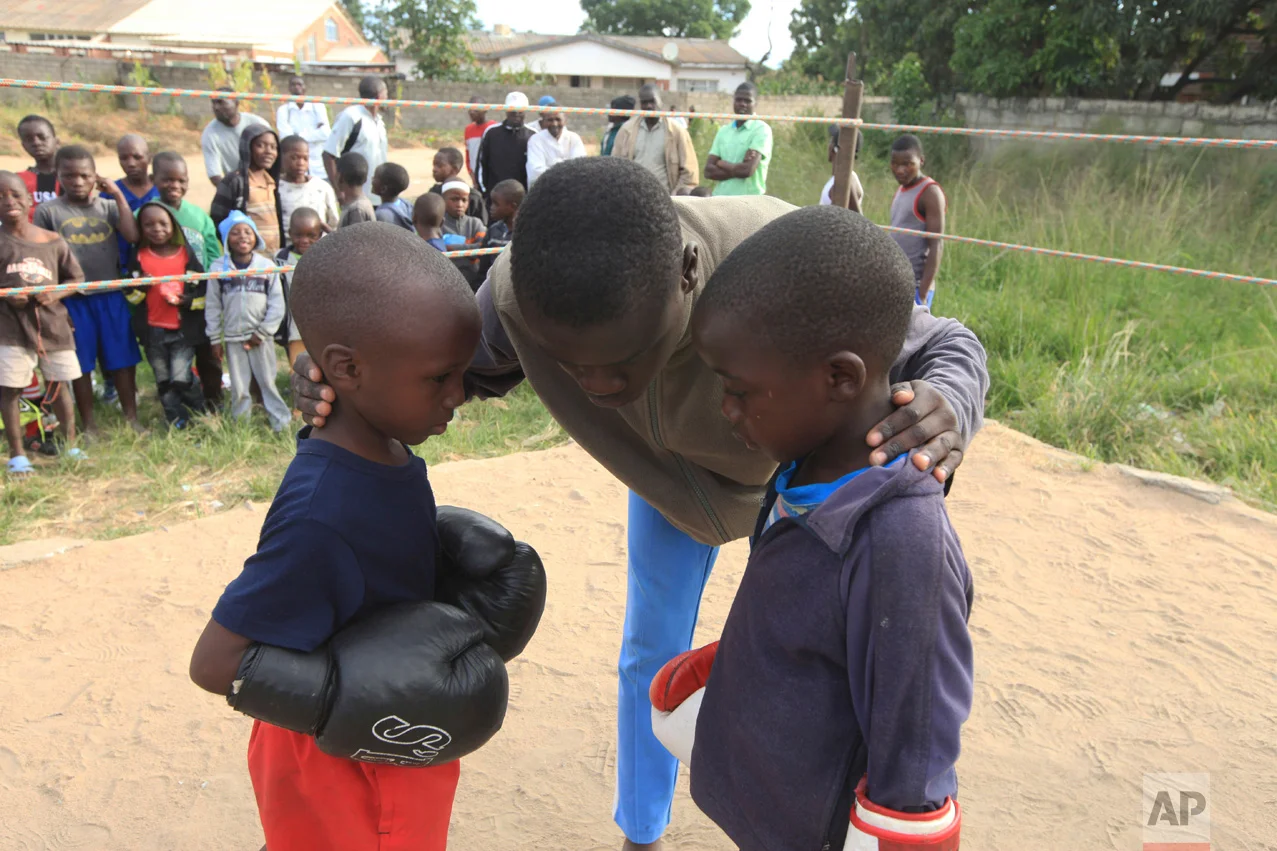 In this Sunday, March 11, 2017 photo, a referee gives children instructions before they fight, in a boxing ring in Chitungwiza. (AP Photo/Tsvangirayi Mukwazhi)