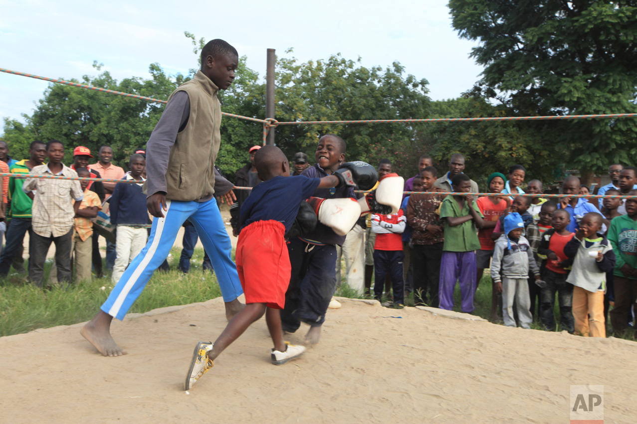 In this Sunday, March 11, 2017 photo, children fight in a boxing ring in Chitungwiza, Zimbabwe. (AP Photo/Tsvangirayi Mukwazhi)