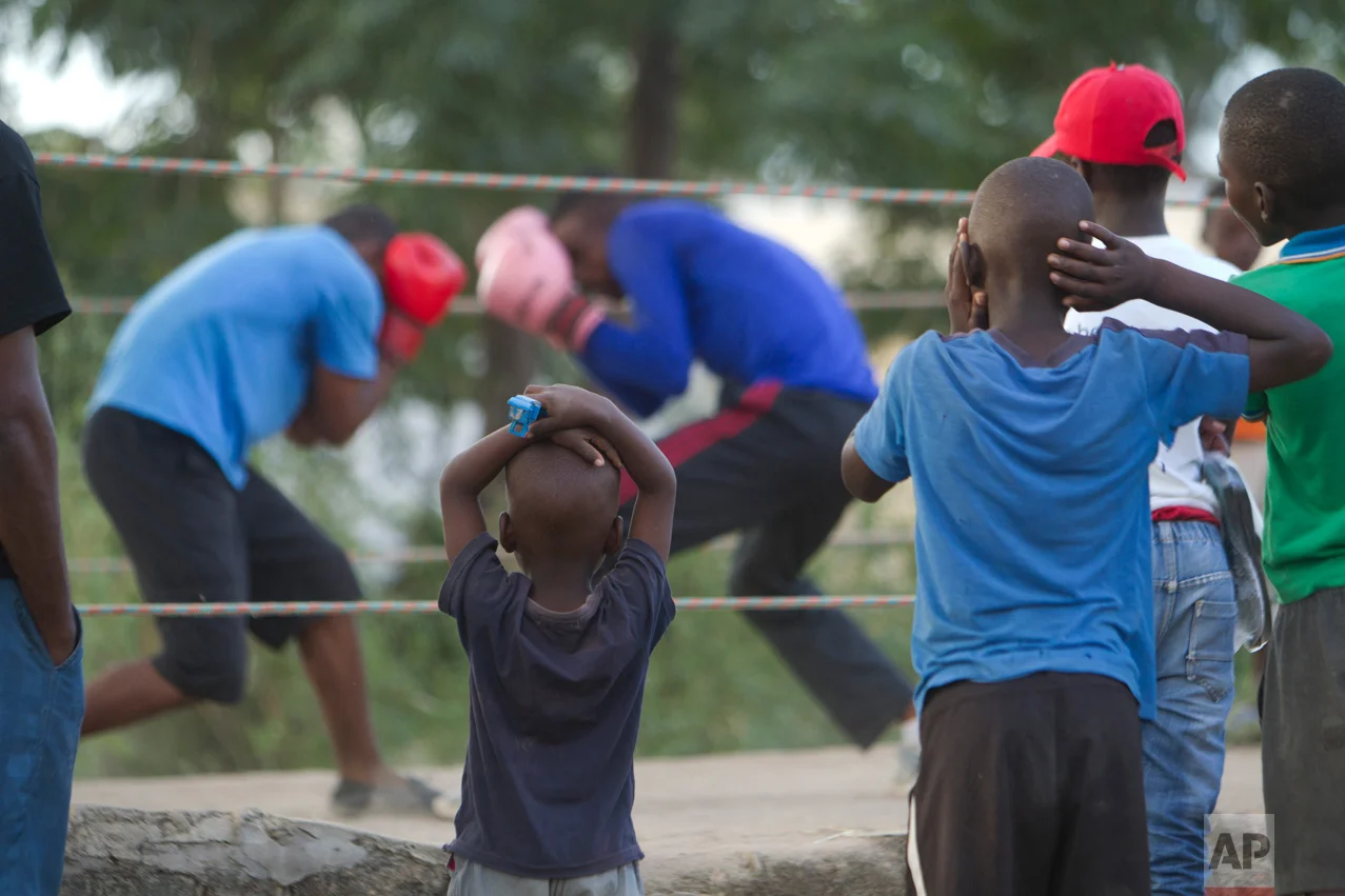 In this Sunday, March 18, 2017 photo, children follow a boxing match in Chitungwiza about 30 kilometres south east of Harare. i(AP Photo/Tsvangirayi Mukwazhi)