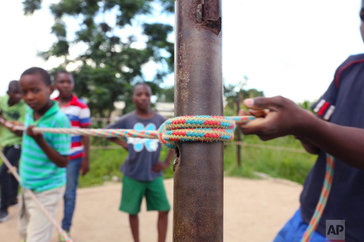 In this Saturday, Feb. 12, 2017 photo, children prepare a boxing ring in Chitungwiza, ZImbabwe. (AP Photo/Tsvangirayi Mukwazhi)