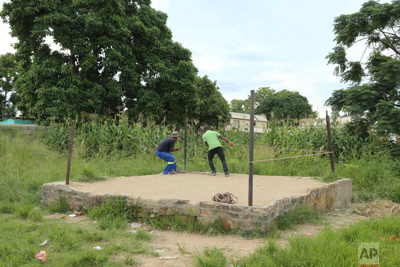In this Saturday, Feb. 12, 2017 photo, organisers set up a boxing ring in Chitungwiza, Zimbabwe. (AP Photo/Tsvangirayi Mukwazhi)